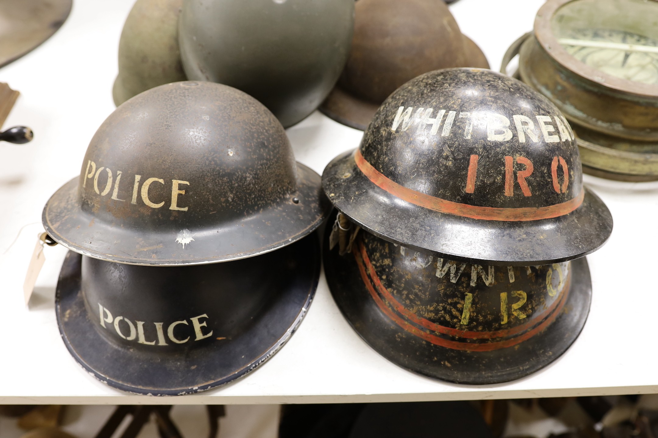 Seven various wartime steel helmets